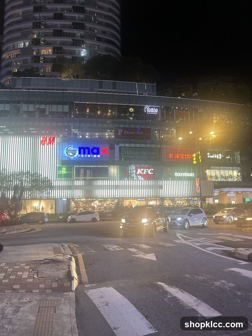 Night view of a shopping complex with various brand signs