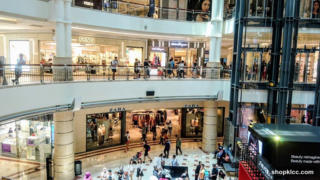 Busy shopping mall interior with multiple levels and stores