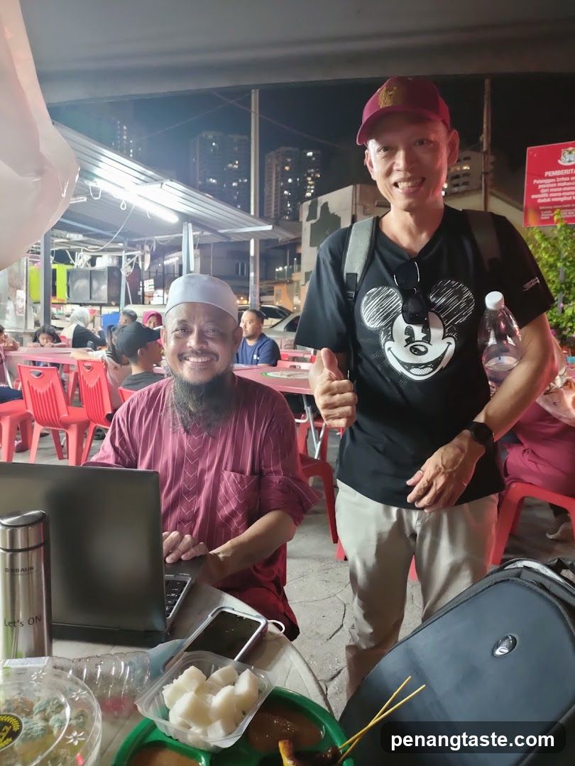 Two men at an outdoor food stall