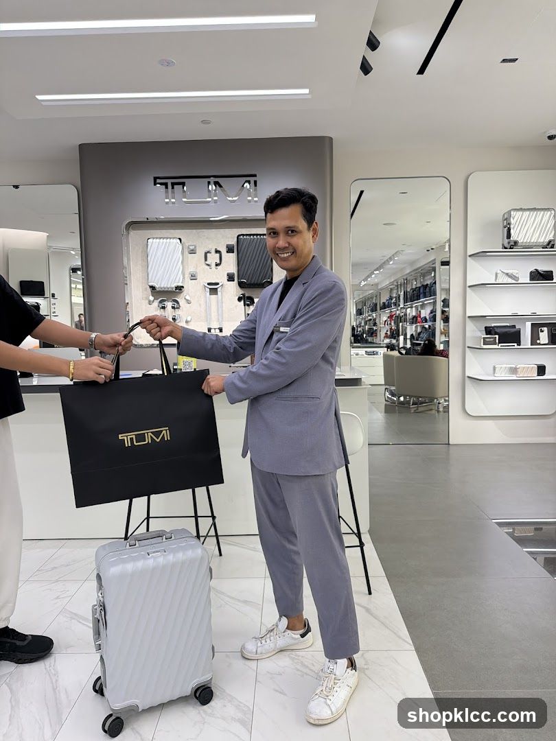 Sales Associate Handing Over a TUMI Shopping Bag
