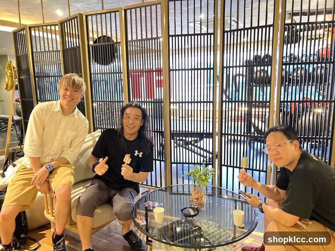 Three men enjoying ice cream in a cafe