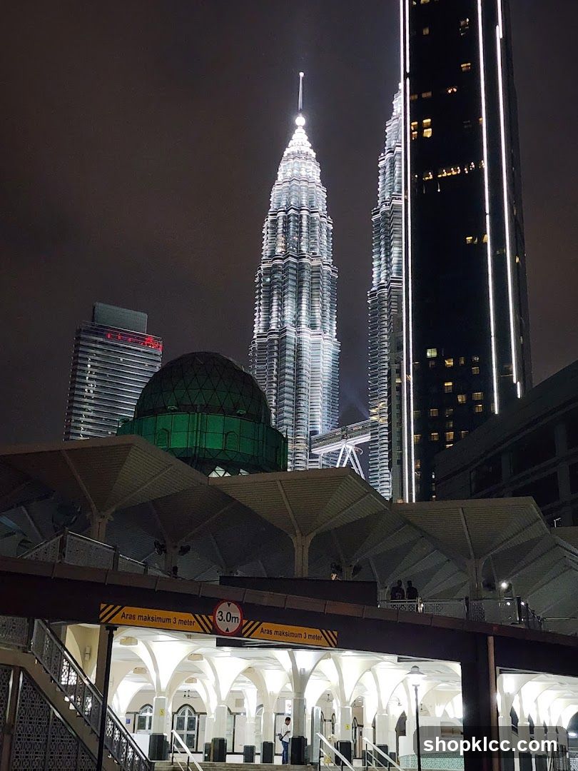 Night view of Petronas Towers and surrounding buildings