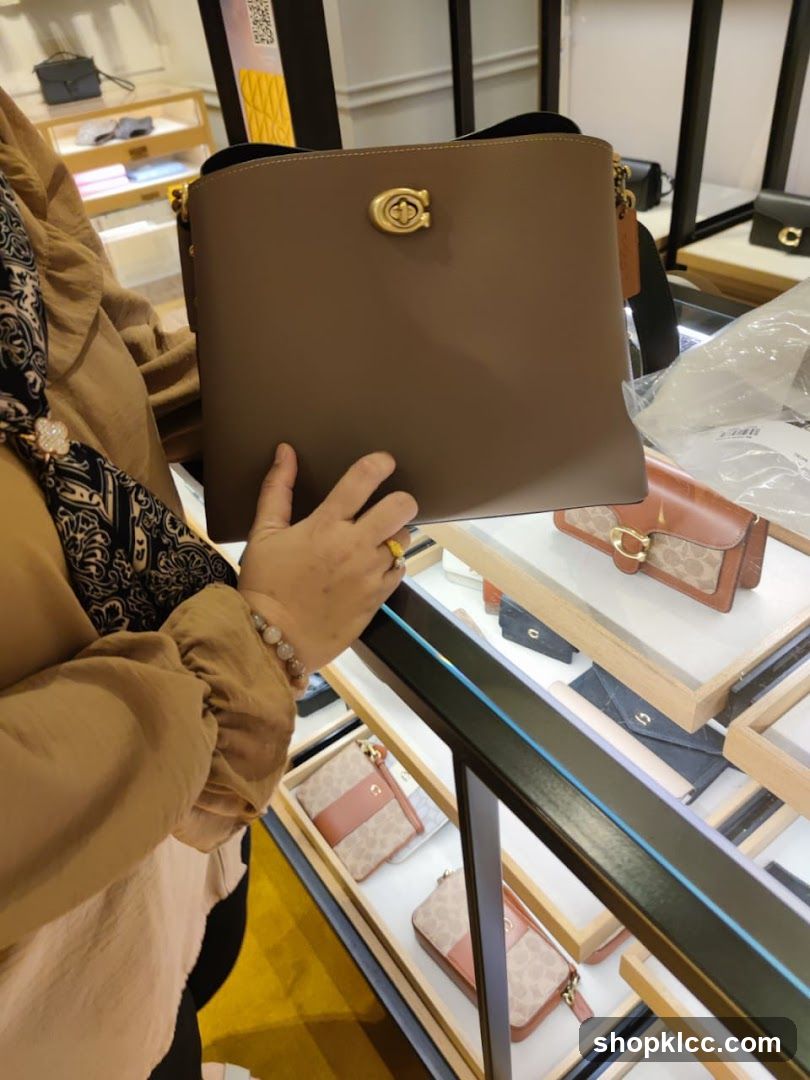 Woman holding a brown handbag in a store