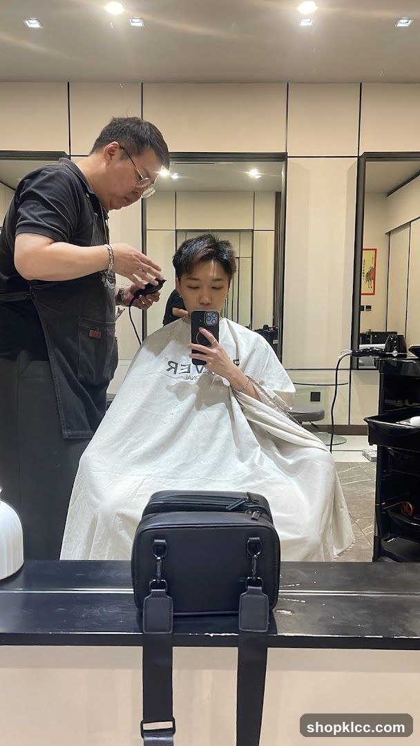 Hairdresser cutting client's hair
