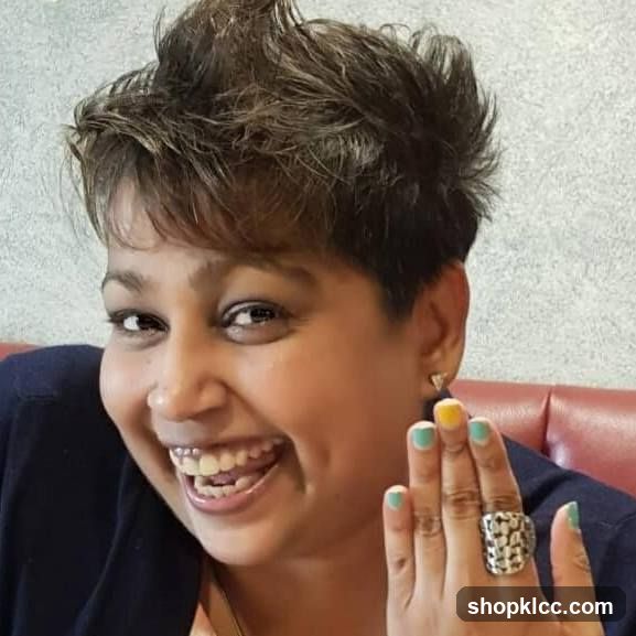 Woman smiling and showing her rings