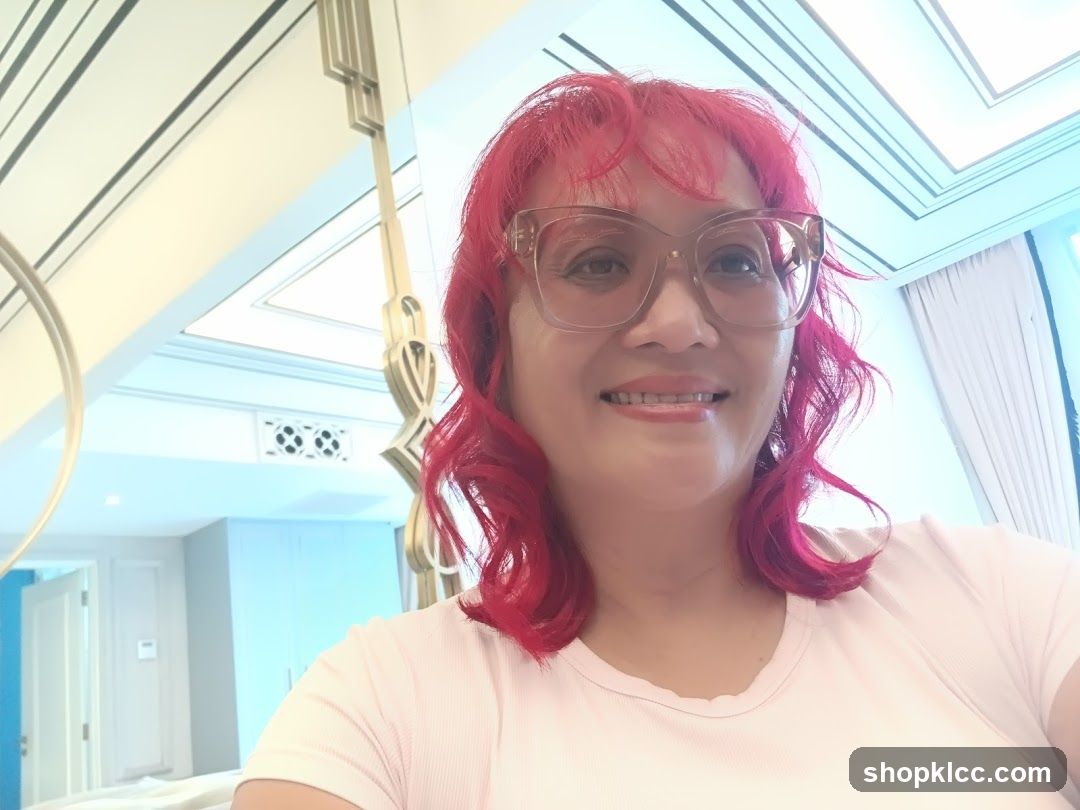 Woman with pink hair and glasses