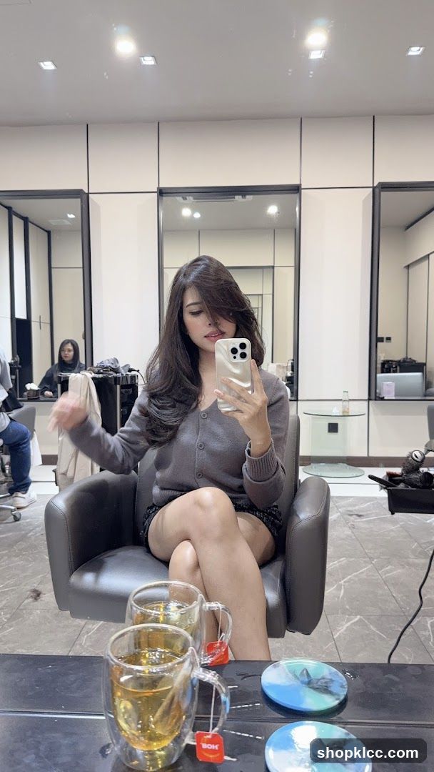 Woman taking a selfie in a salon