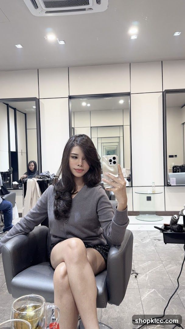 Woman taking a selfie in a salon
