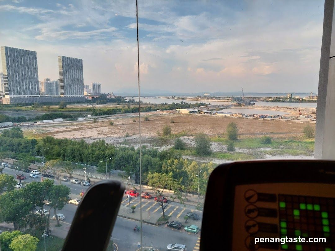 View from a window overlooking a city and construction site