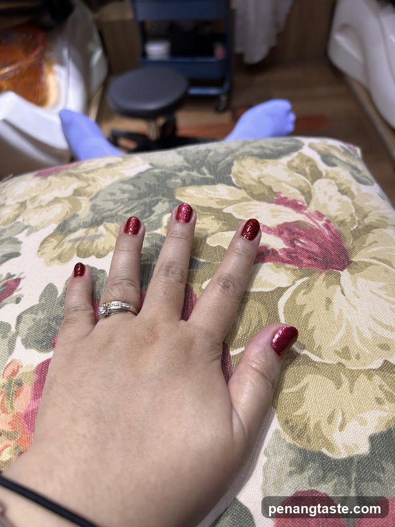 Hand with red glitter nails