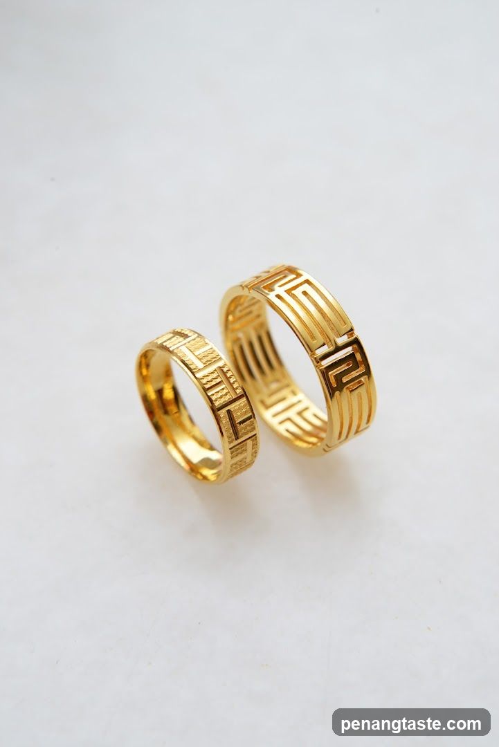 Two gold rings with geometric patterns
