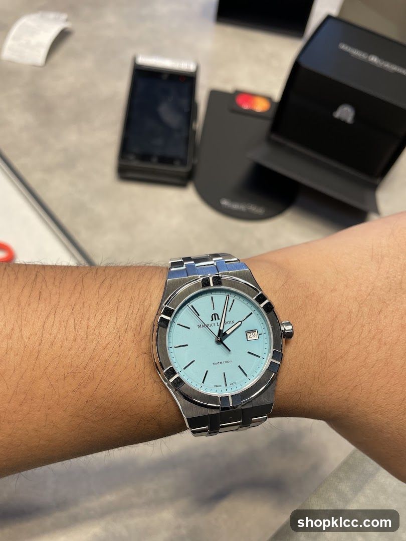 Watch on wrist with payment terminal in background