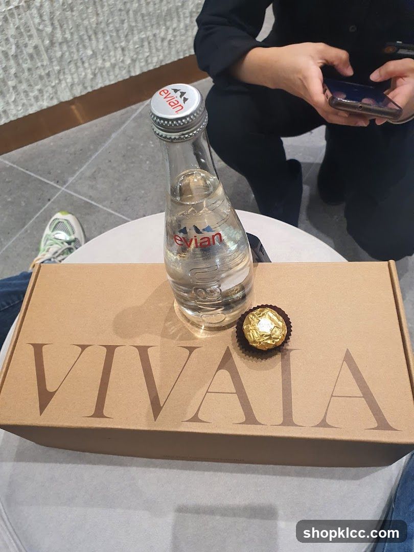 Evian water bottle and Ferrero Rocher chocolate on a box