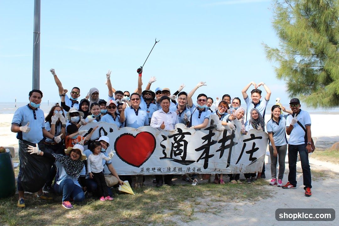 Group posing with banner on beach