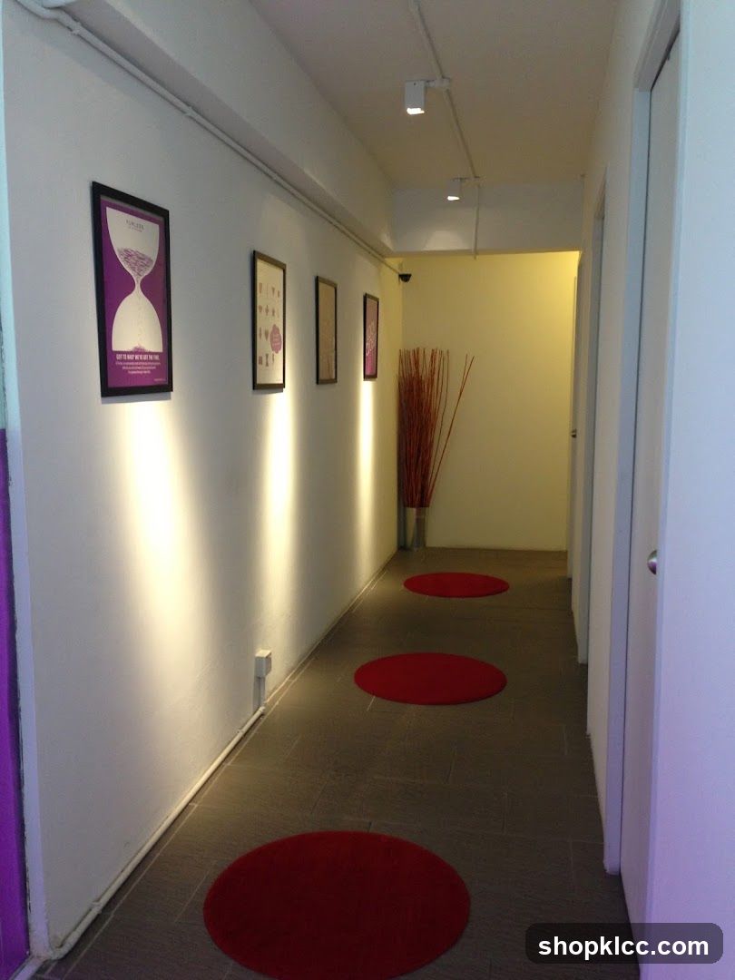 Hallway with artwork and red circular rugs