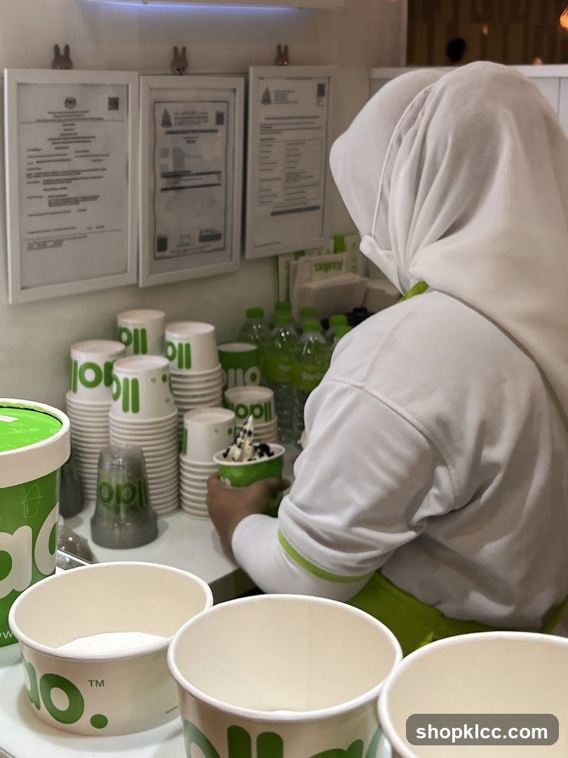 Staff preparing a frozen yogurt order