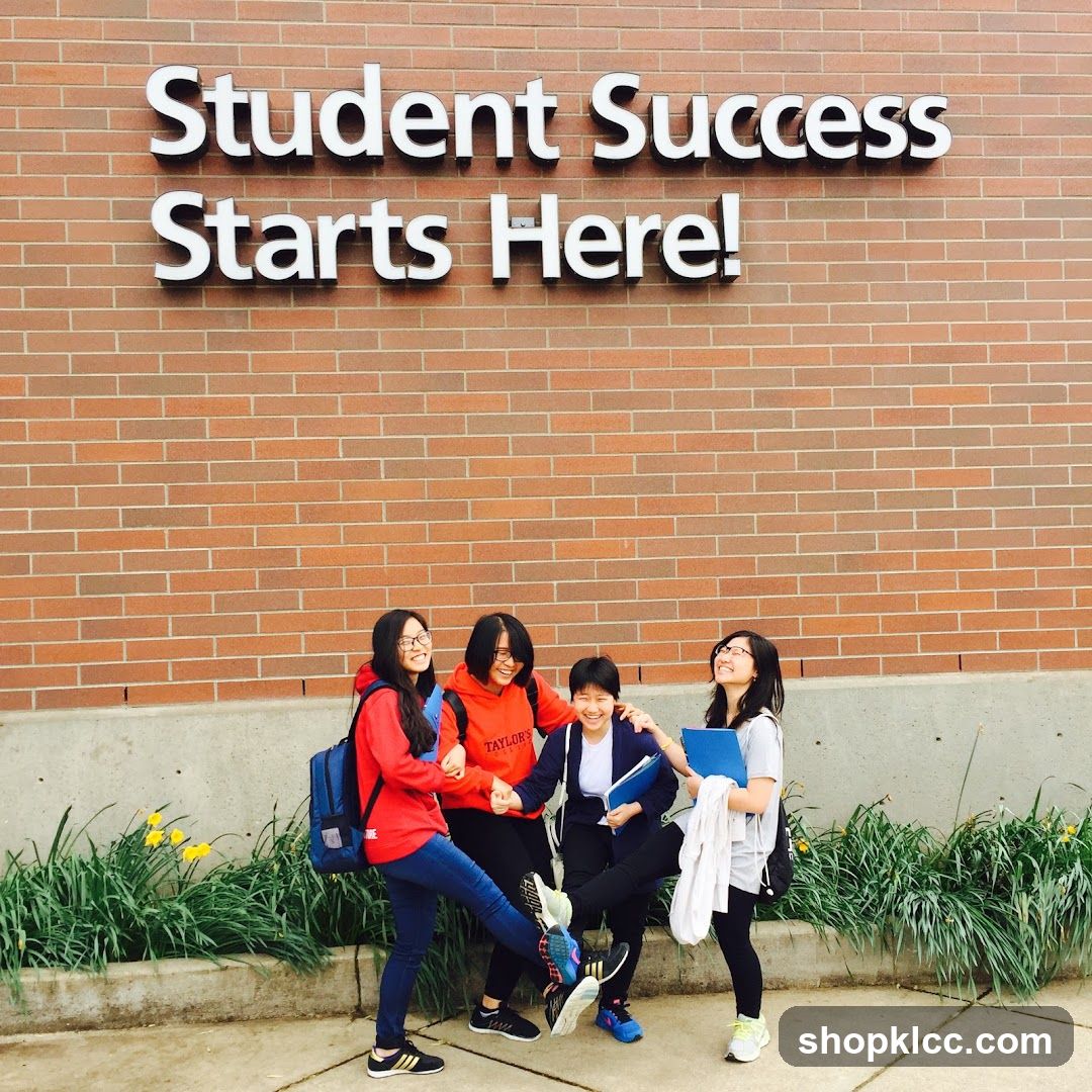 Students posing in front of a brick wall with text