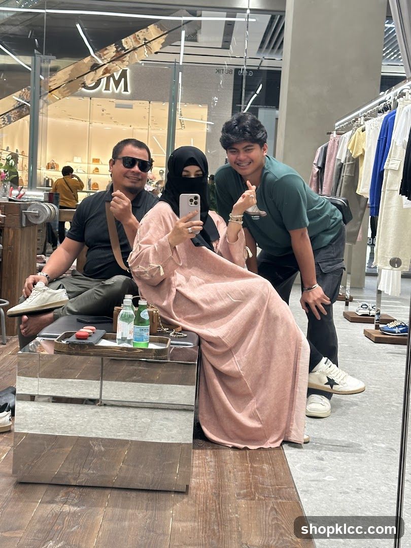 People posing for a mirror selfie in a store