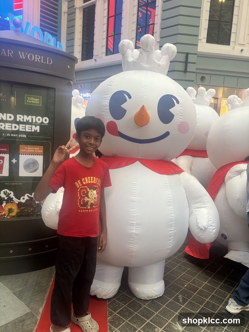 Boy Posing with Inflatable Snowman