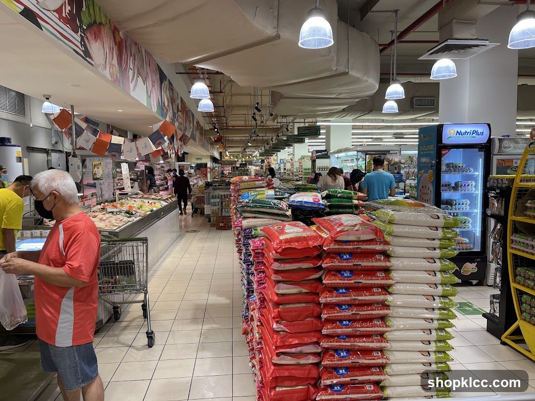 Supermarket aisle with stacked rice bags and refrigerated display