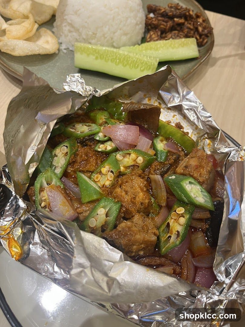Foil-wrapped dish with rice and sides