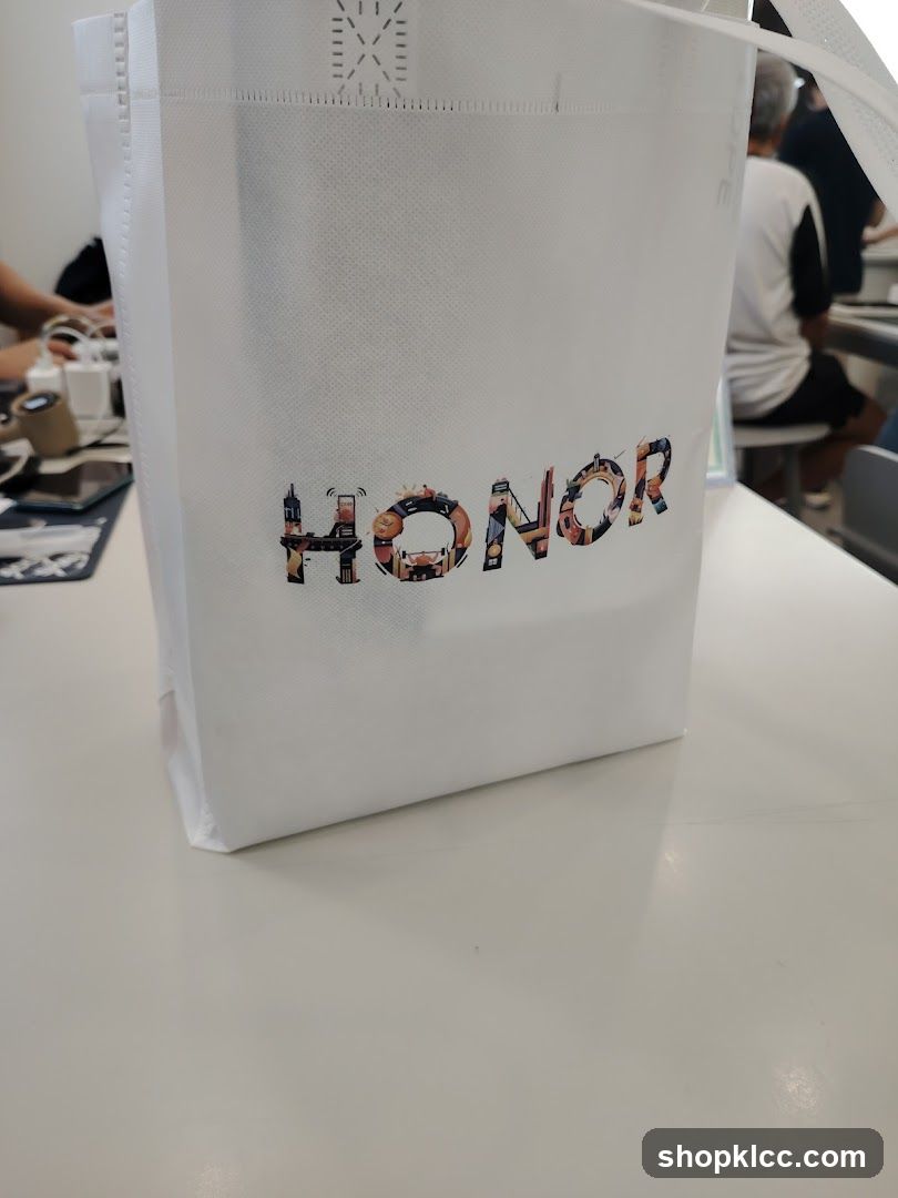 White tote bag with "HONOR" logo
