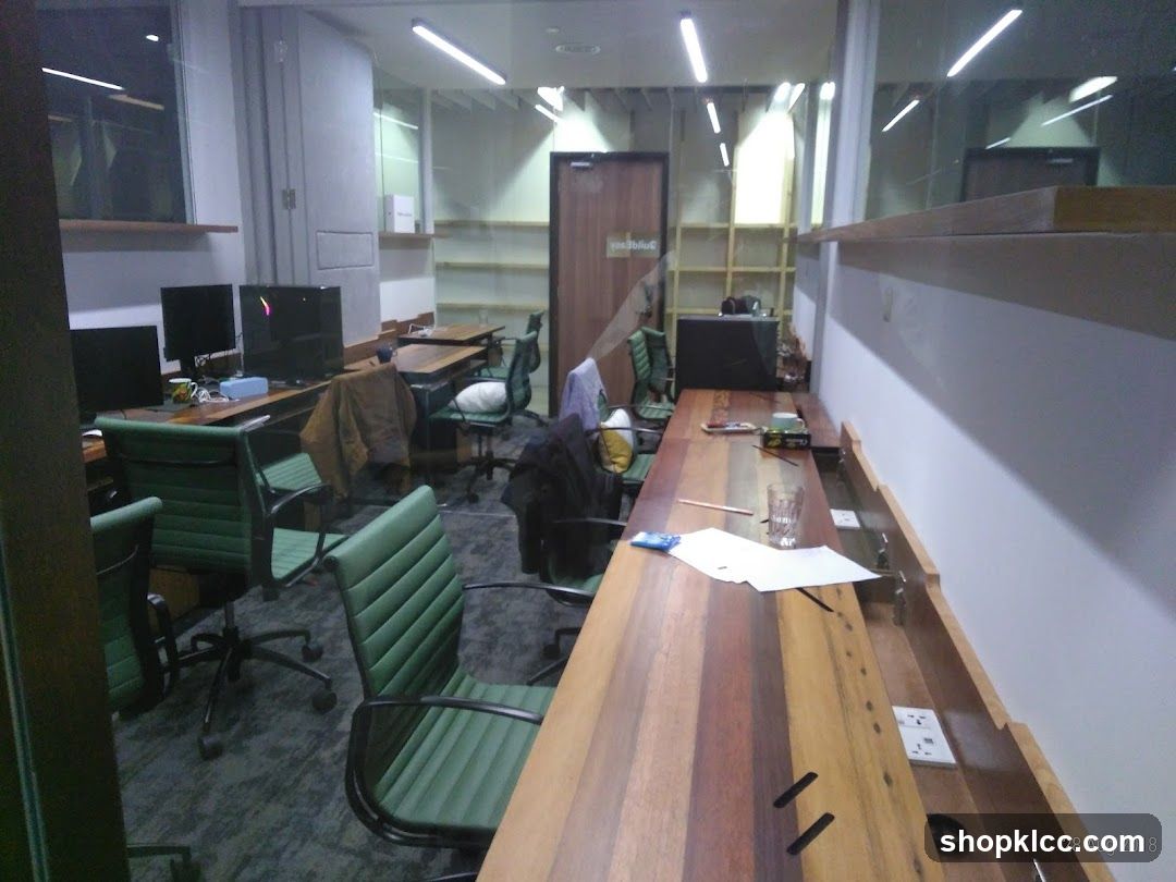 Office Interior with Green Chairs and Wooden Desks
