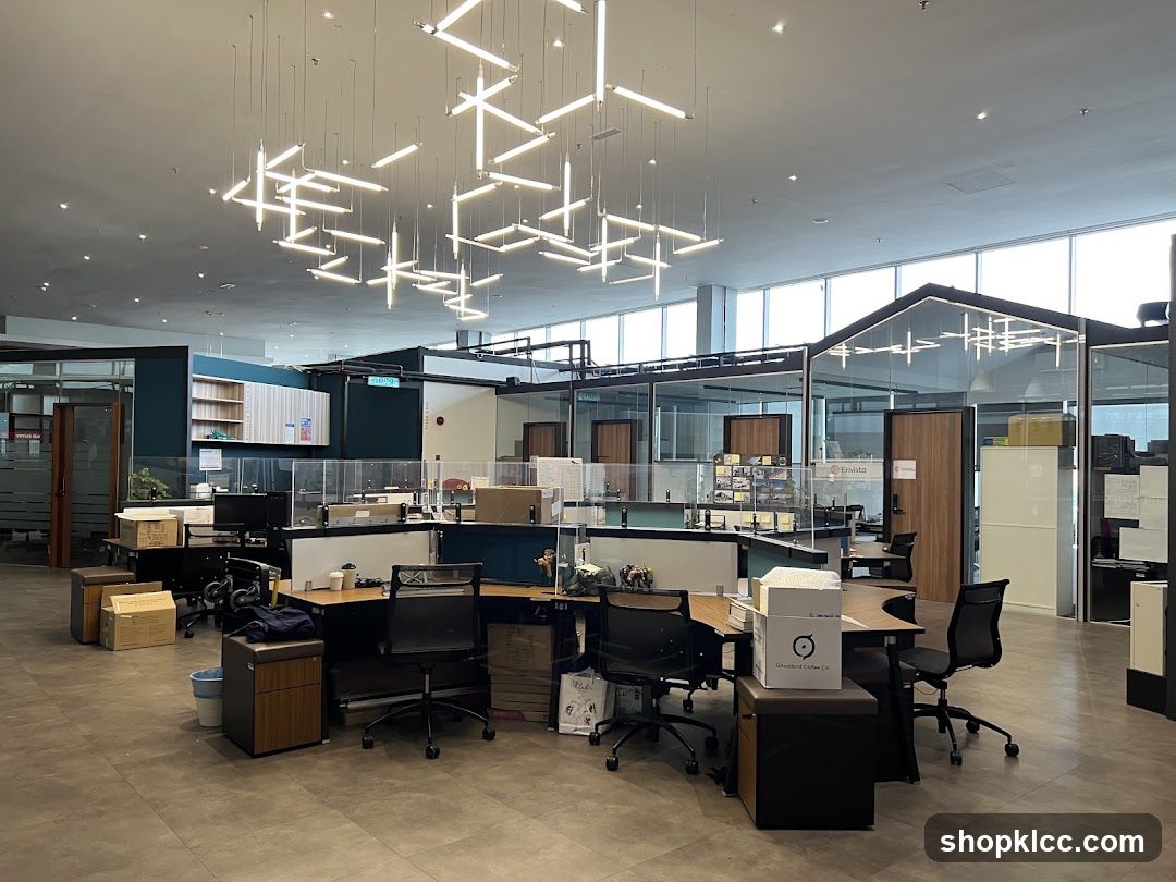 Modern Office Interior with Glass Partitions and Hanging Lights