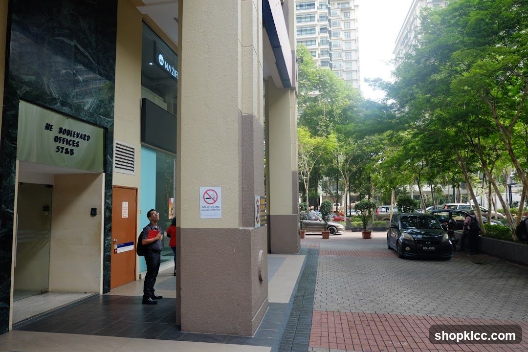 Office Building Entrance with Trees and Cars