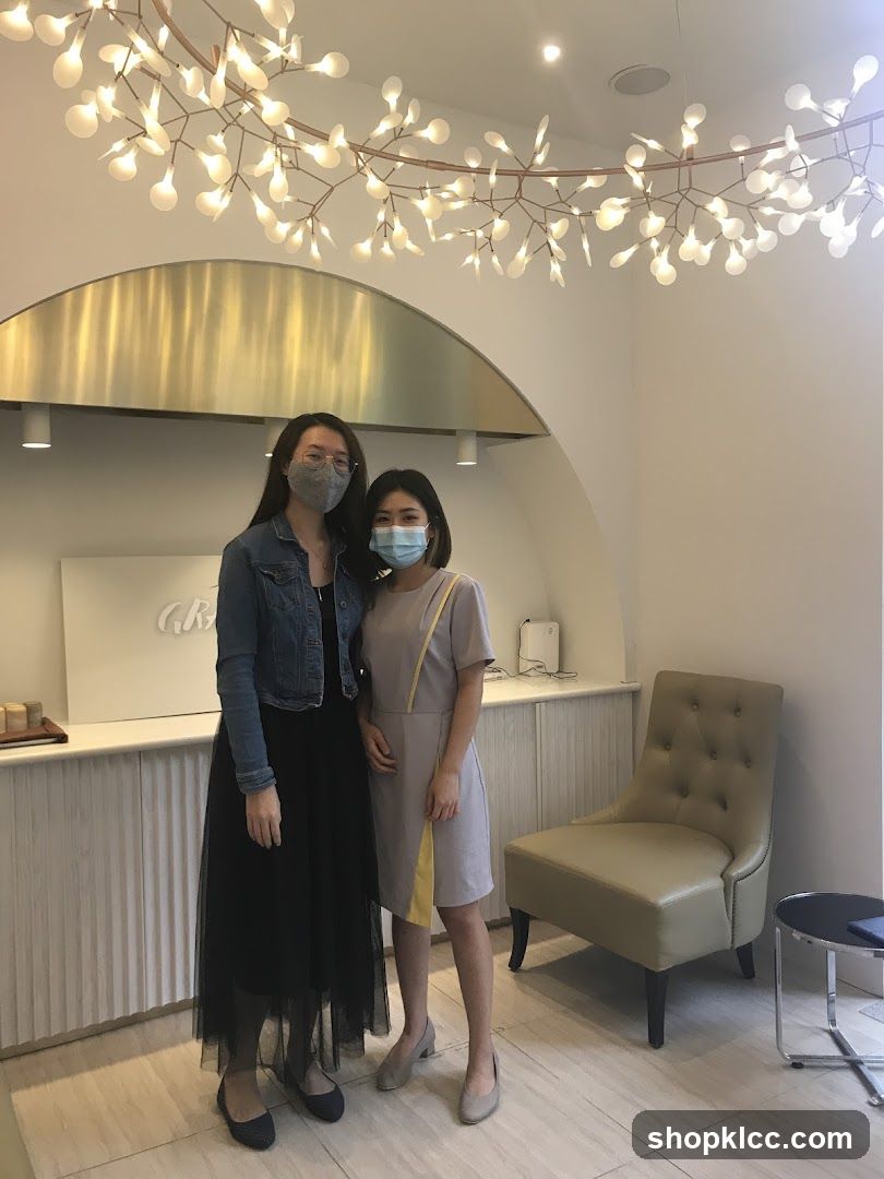 Two women posing in a well-lit interior