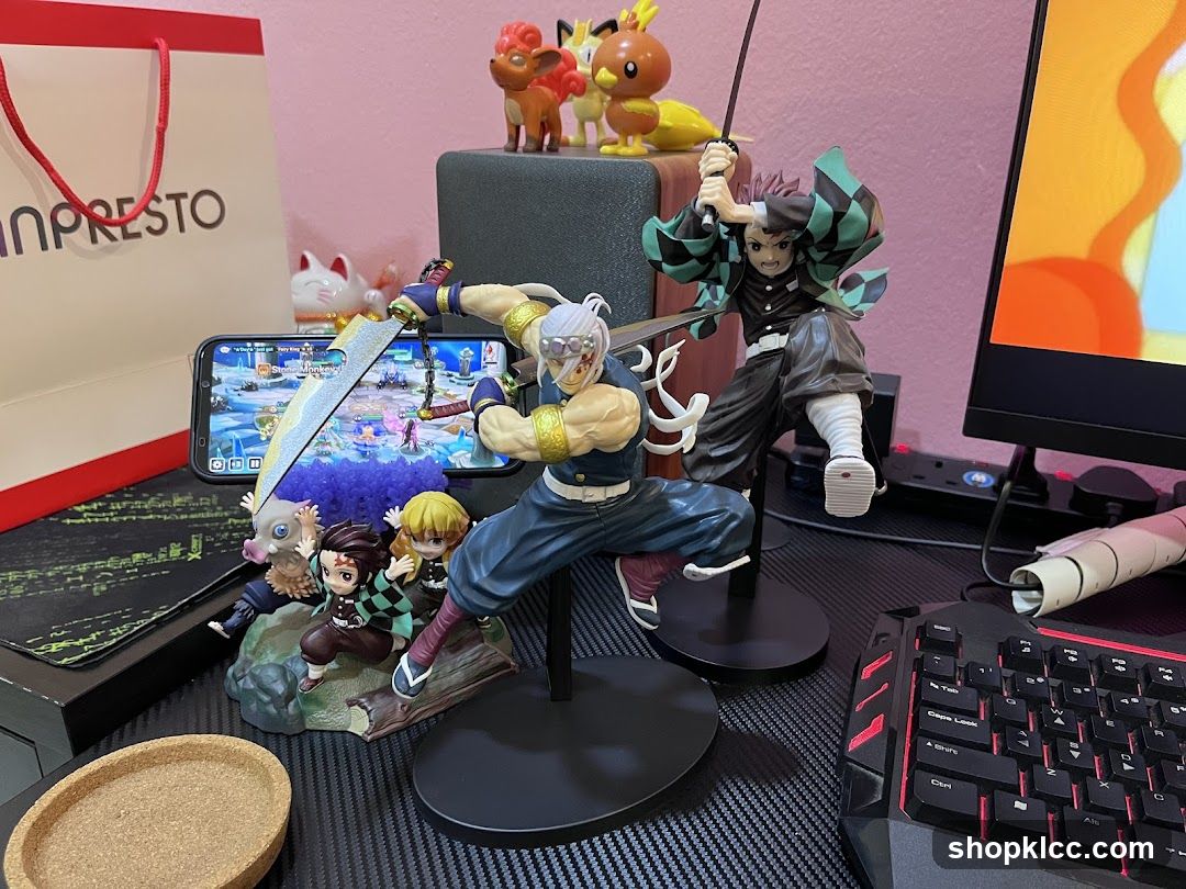 Demon Slayer and One Piece figurine display on desk