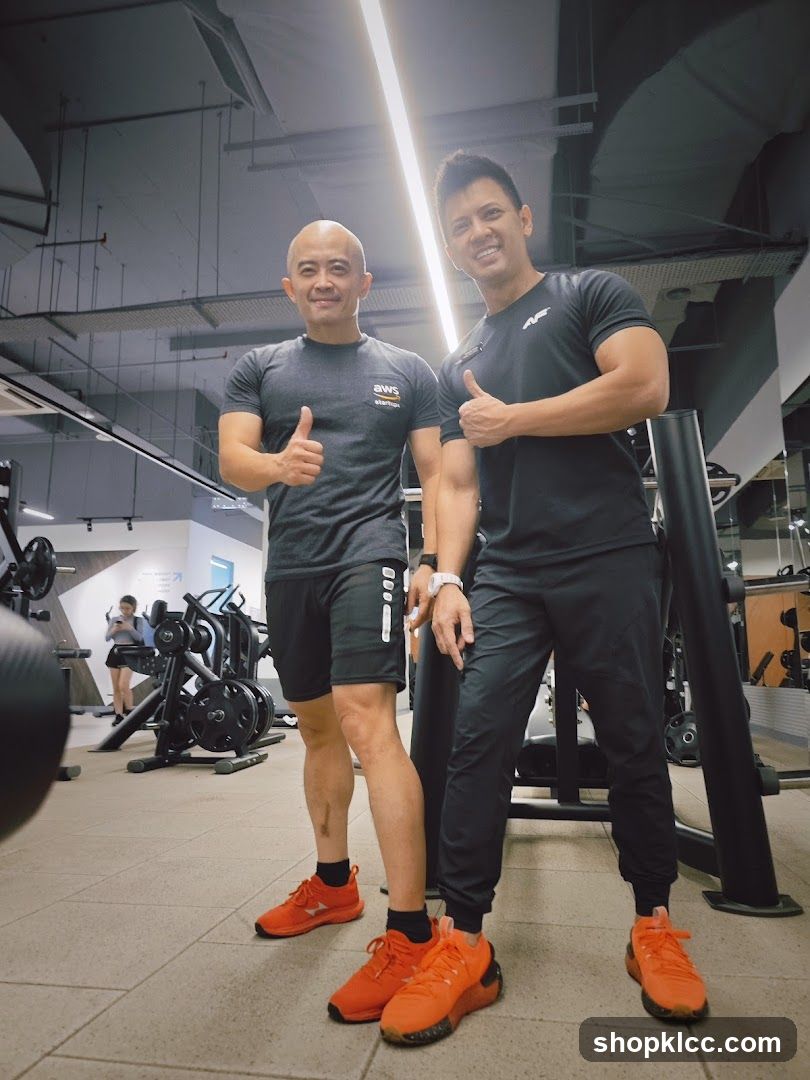 Gym Interior with Two Men Giving Thumbs Up