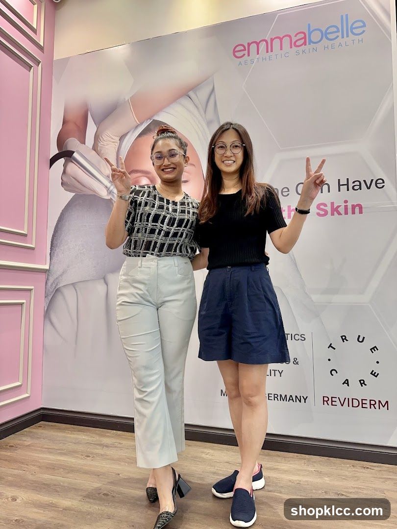 Two women posing in front of a beauty clinic wall