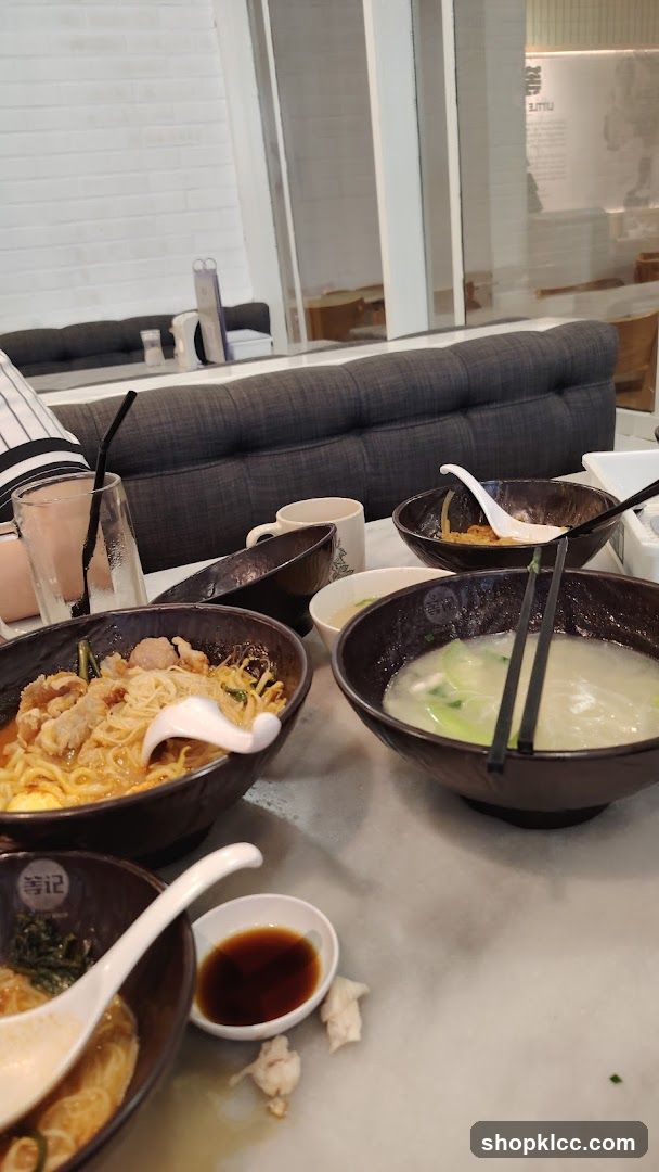 Dining Table with Bowls of Noodles and Soup
