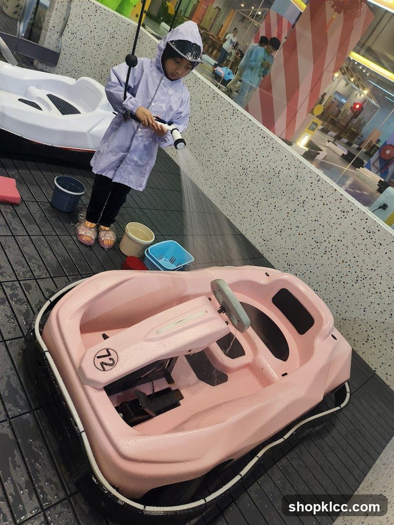 Child Washing a Pink Boat at Indoor Play Area