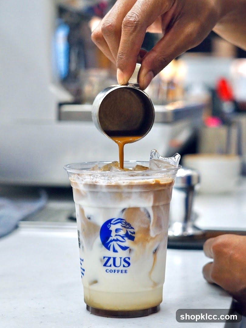 Pouring espresso into iced coffee