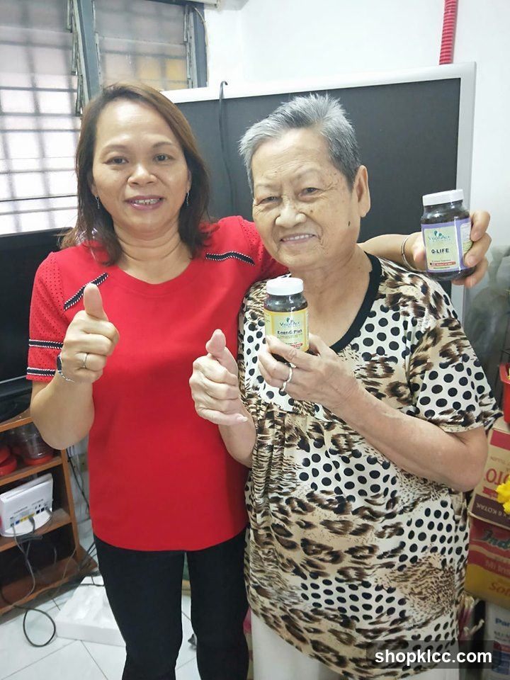 Two women holding supplement bottles