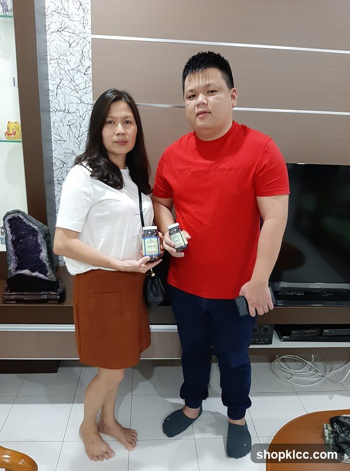 Couple Holding Product Jars Indoors