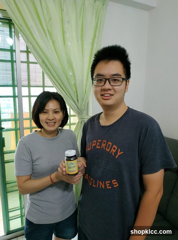 Two people holding a supplement bottle