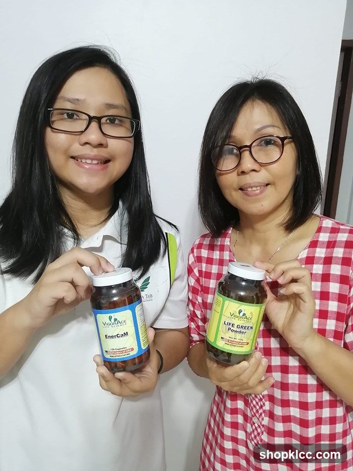 Two women holding health supplement jars