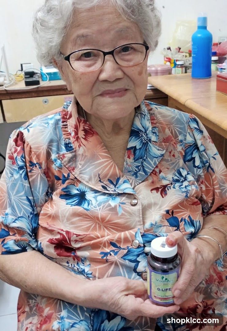 Elderly woman holding supplement bottle