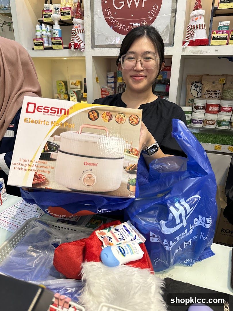 Woman holding a Dessini Electric Hot Pot box