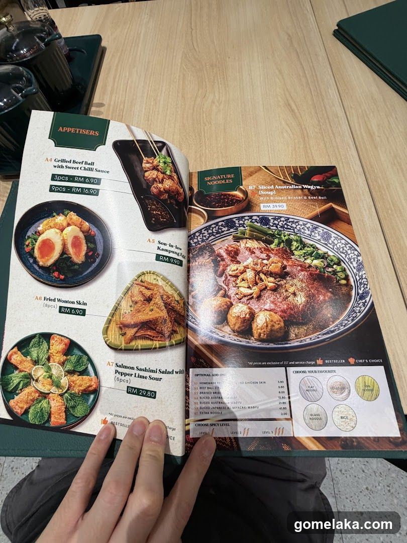 Restaurant Menu Opened to Appetizers and Signature Noodles Section