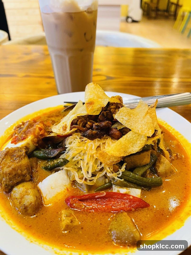 Curry Noodle Dish with Chips and Iced Drink