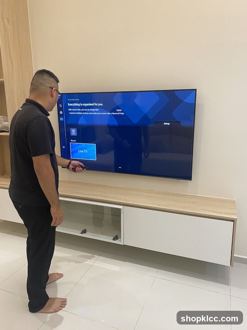 Man Setting Up Smart TV