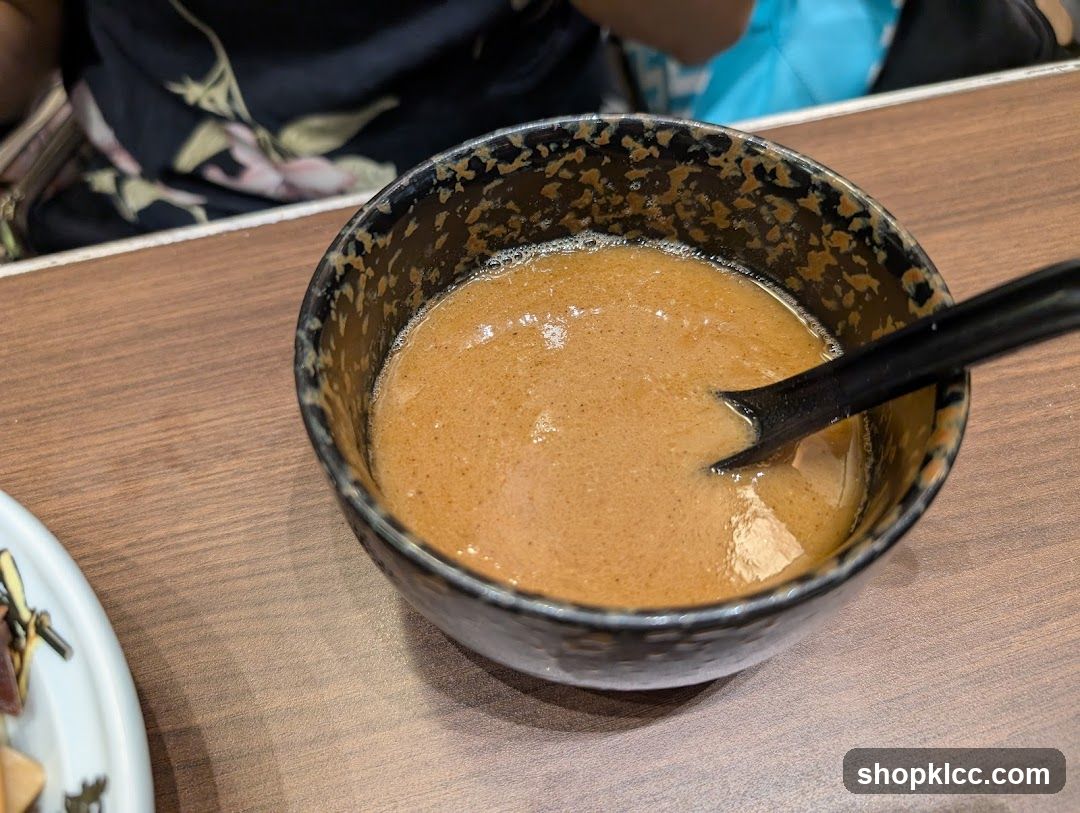 Bowl of Brown Soup with Spoon