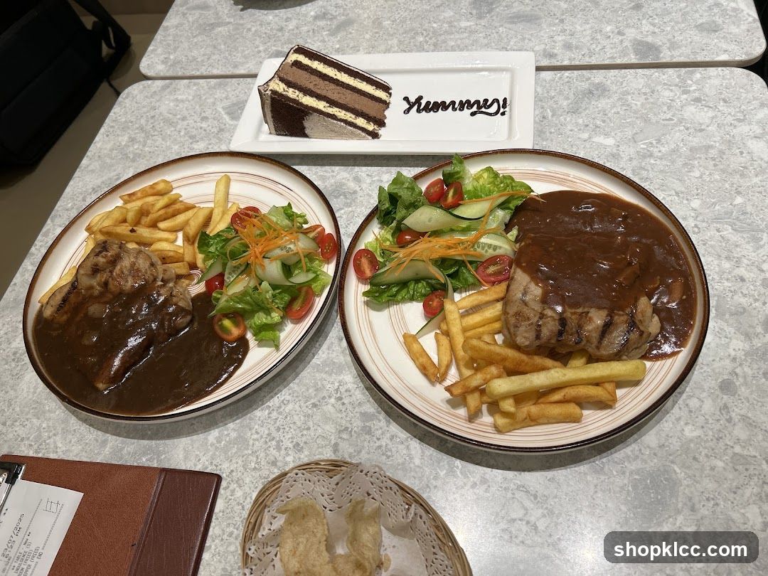 Two plates of steak with fries and salad, and a slice of chocolate cake