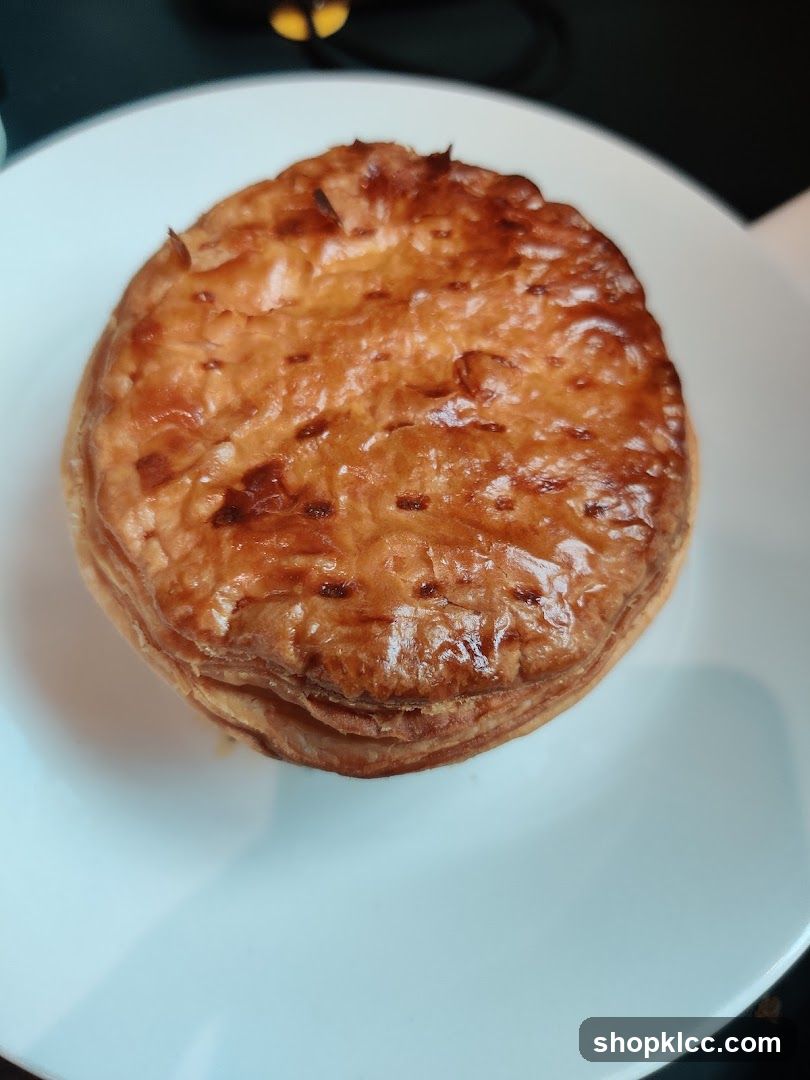 Golden brown pie on a white plate
