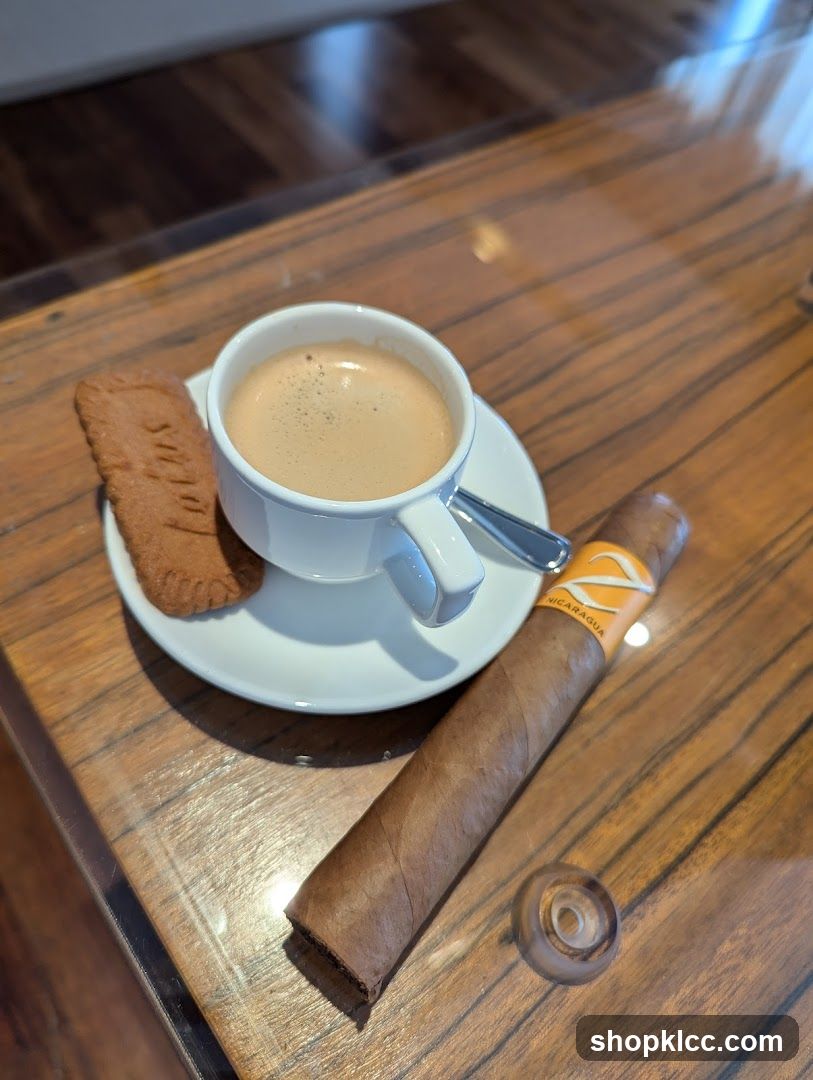 Cup of coffee with biscuit and cigar