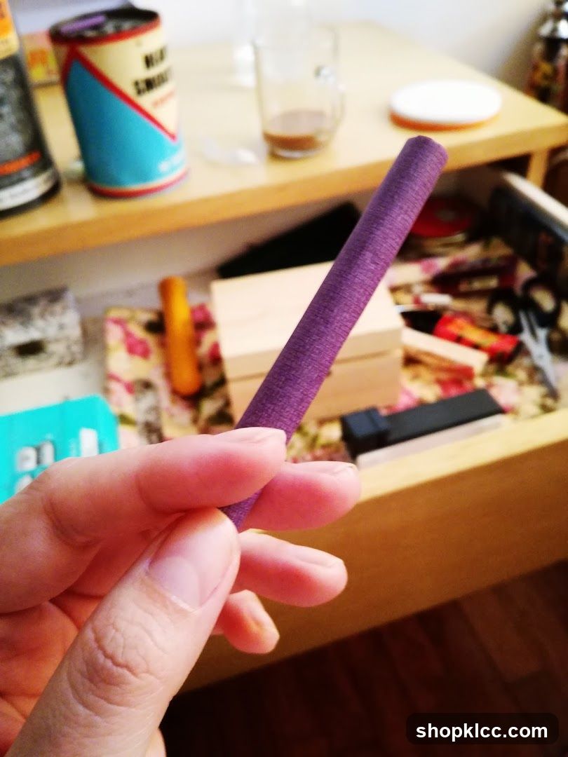 Purple Cylinder Held in Hand